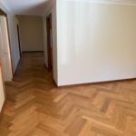 Herringbone timber floor in a bright hallway