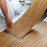 Installer laying a timber-look hybrid plank